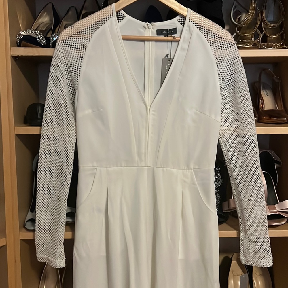 White jumpsuit with fishnet mesh sleeves,includes pocketsNever worn tag attached
